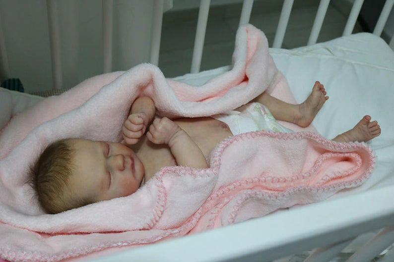 reborn-doll-in-cradle Reborn Doll Care Instructions